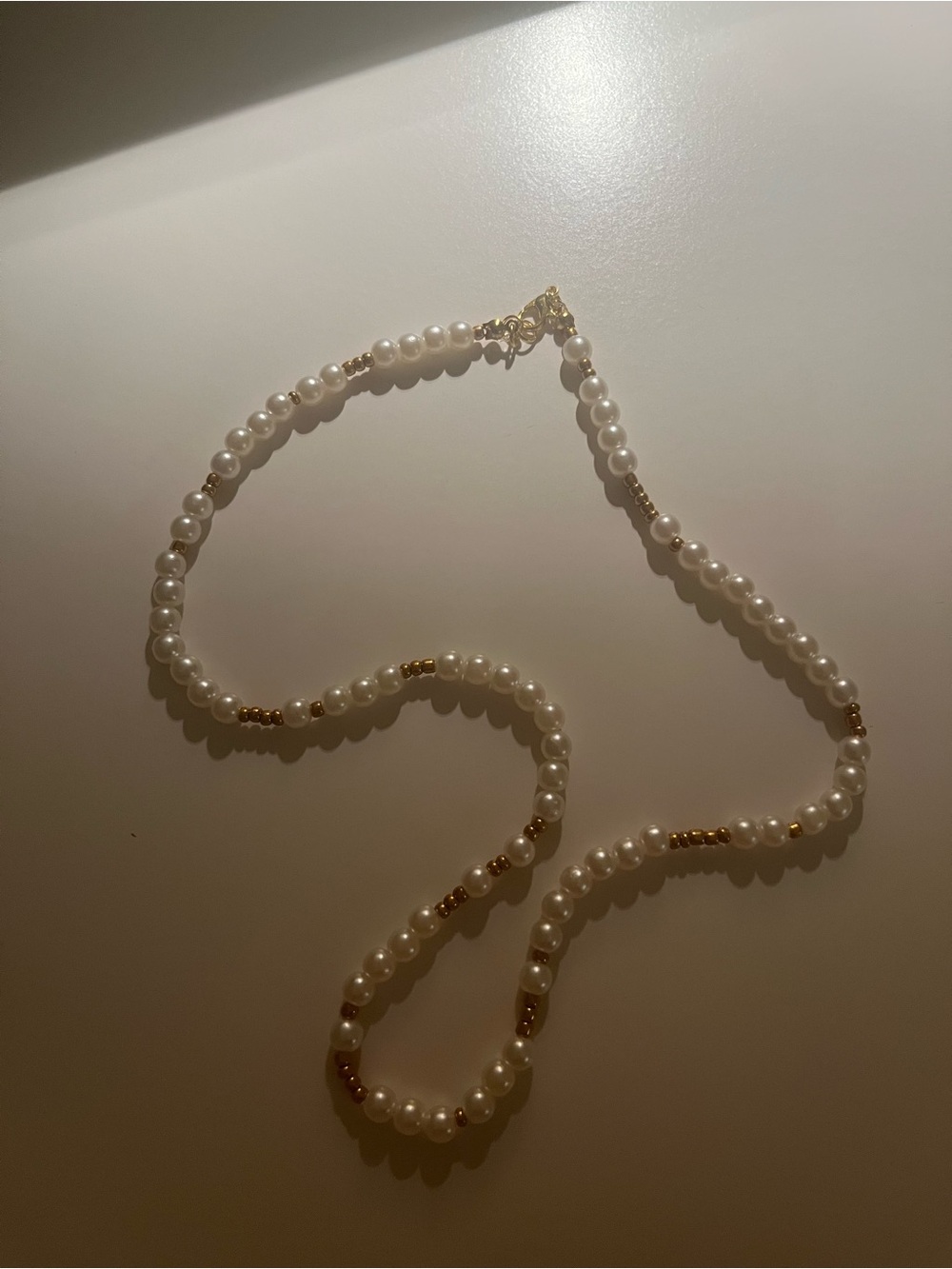 Timeless White Pearl Necklace with Gold Bead Accents